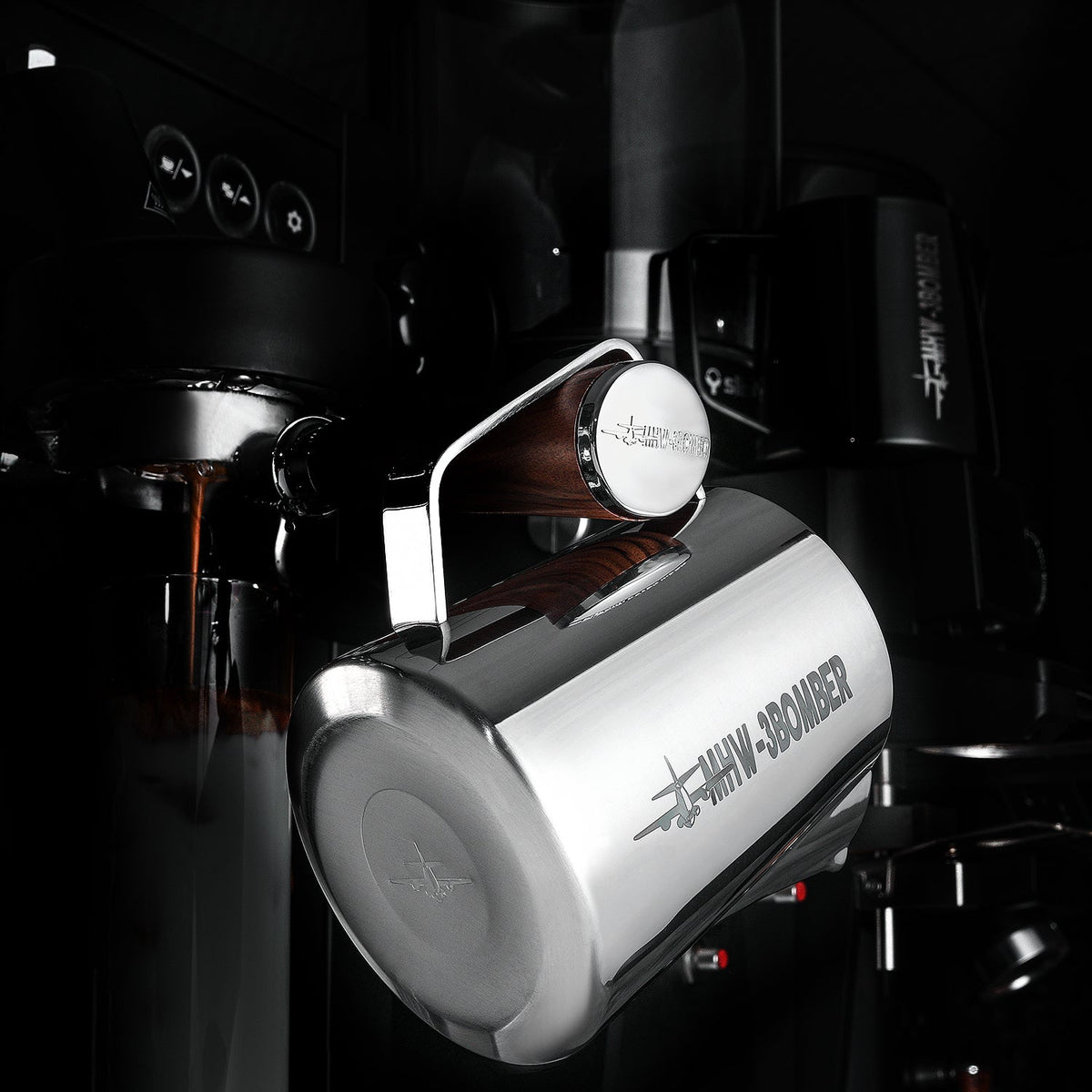 A MHW-3BOMBER Latte Art Trio Bundle pitcher labeled “49MM BOMBER” is attached to an espresso machine, pouring coffee into a cup in a sleek, modern setting.