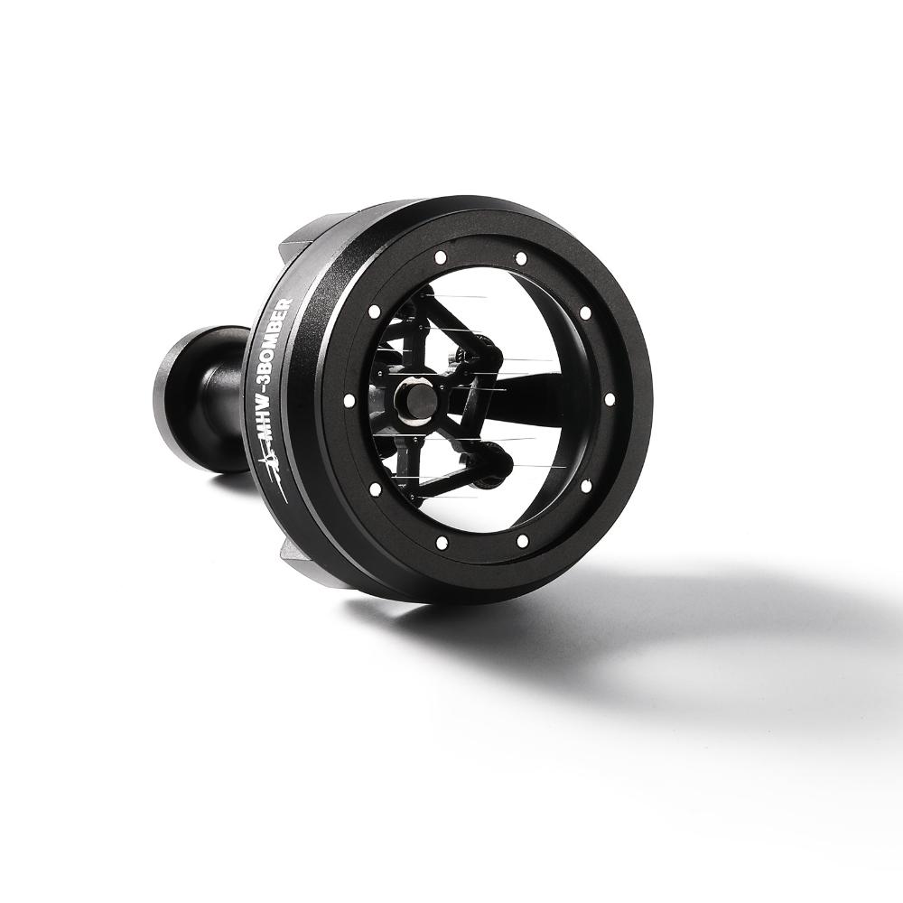 A black MHW-3BOMBER YU-Series Cyclone Needle WDT Distributor Tool 58mm lies on its side, showcasing a circular frame with glass center and visible stainless steel needles for precise coffee distribution.