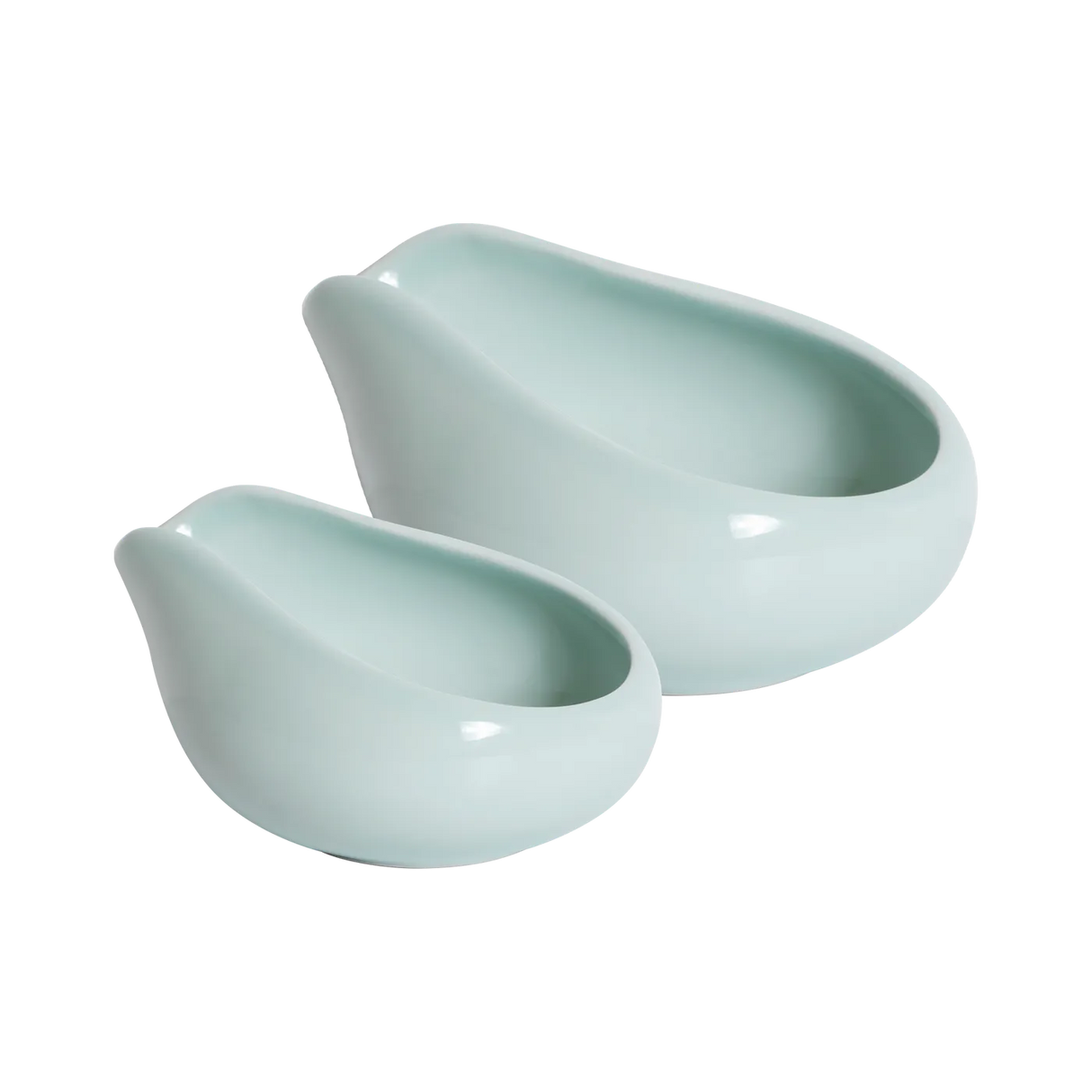 Two celadon blue, glossy ceramic trays with rounded shapes and wide, slanted openings from Loveramics are placed side by side on a white background. Reminiscent of a refined porcelain coffee accessory featured by James Hoffmann, the Loveramics Coffee Dosing Tray Set of 2 showcases one larger and one smaller tray appearing neatly nested together.
