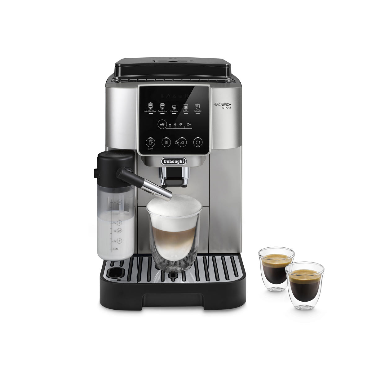 The DeLonghi Magnifica Start Super Automatic Espresso Machine with LatteCrema System ECAM22080SB (Silver) sits on the counter, its sleek silver and black design complemented by a digital display and clearly labeled buttons for various coffee options. Featuring a built-in conical burr grinder to ensure freshly ground beans for each brew, the machine uses its LatteCrema System and integrated milk frother to make a creamy latte, while two small cups of espresso rest beside it.