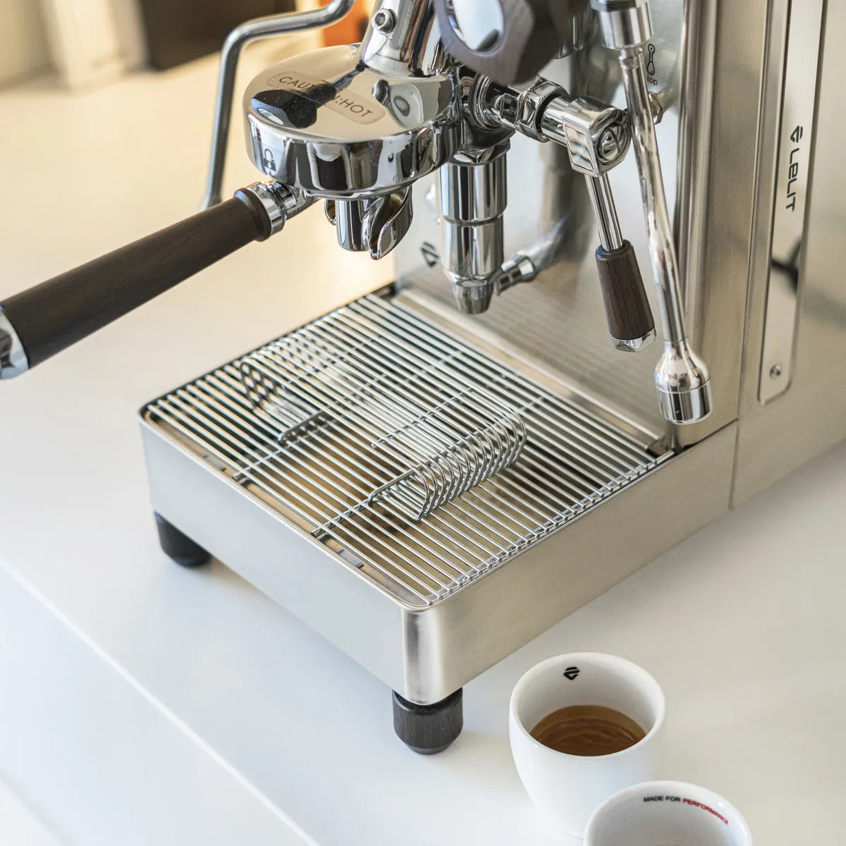 A close-up of the Lelit Mara X3 Semi-Automatic Heat-Exchange Espresso Machine PL62X3 (Stainless Steel) on a countertop, with two white espresso cups nearby; its portafilter and steam wand highlight advanced electronic flow control.