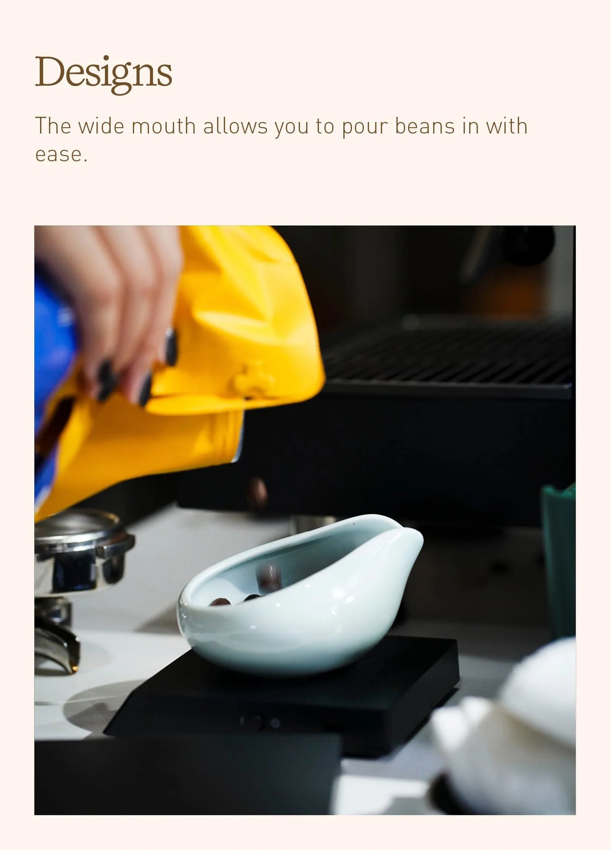 A hand pours coffee beans from a yellow bag into the wide opening of a white ceramic container on the counter, demonstrating how easily beans can be transferred when using a Loveramics Coffee Dosing Tray Set of 2 (Matte Dark Green)—a practical accessory from Loveramics, inspired by James Hoffmann’s precise brewing approach.