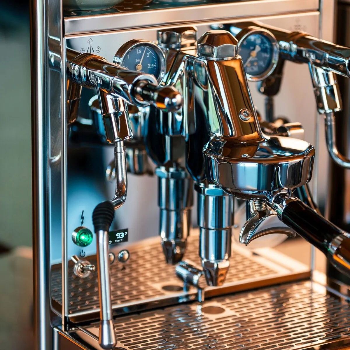 A close-up of the ECM Technika VI Dual Boiler Espresso Machine w/ PID shows its stainless steel body, multiple gauges, levers, and portafilter. The digital display is on, reading 93°C with precise PID temperature control.
