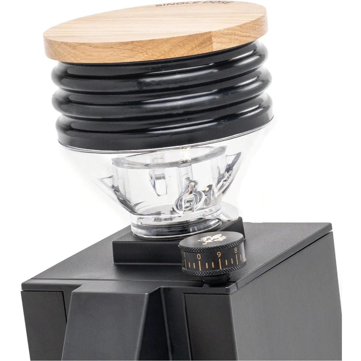 The Eureka Oro Mignon Single Dose Grinder, featuring a sleek black body, ribbed black upper section, and a wooden top cover, includes a clear plastic hopper just below the top. A numbered dial on the front allows for easy grind setting adjustments. This single dose grinder from Eureka ensures near-zero retention grinding for optimal freshness.