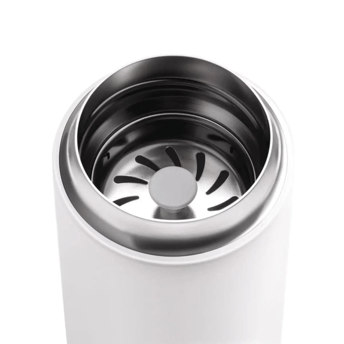 A close-up of the stainless steel interior and lid of the Fellow Carter Move Mug 16oz (Matte White). The lid features a round central area with radial slits that resemble a vent. The smooth, metallic inner surface contrasts with the mug's matte exterior, further enhanced by its snap-in splash guard.
