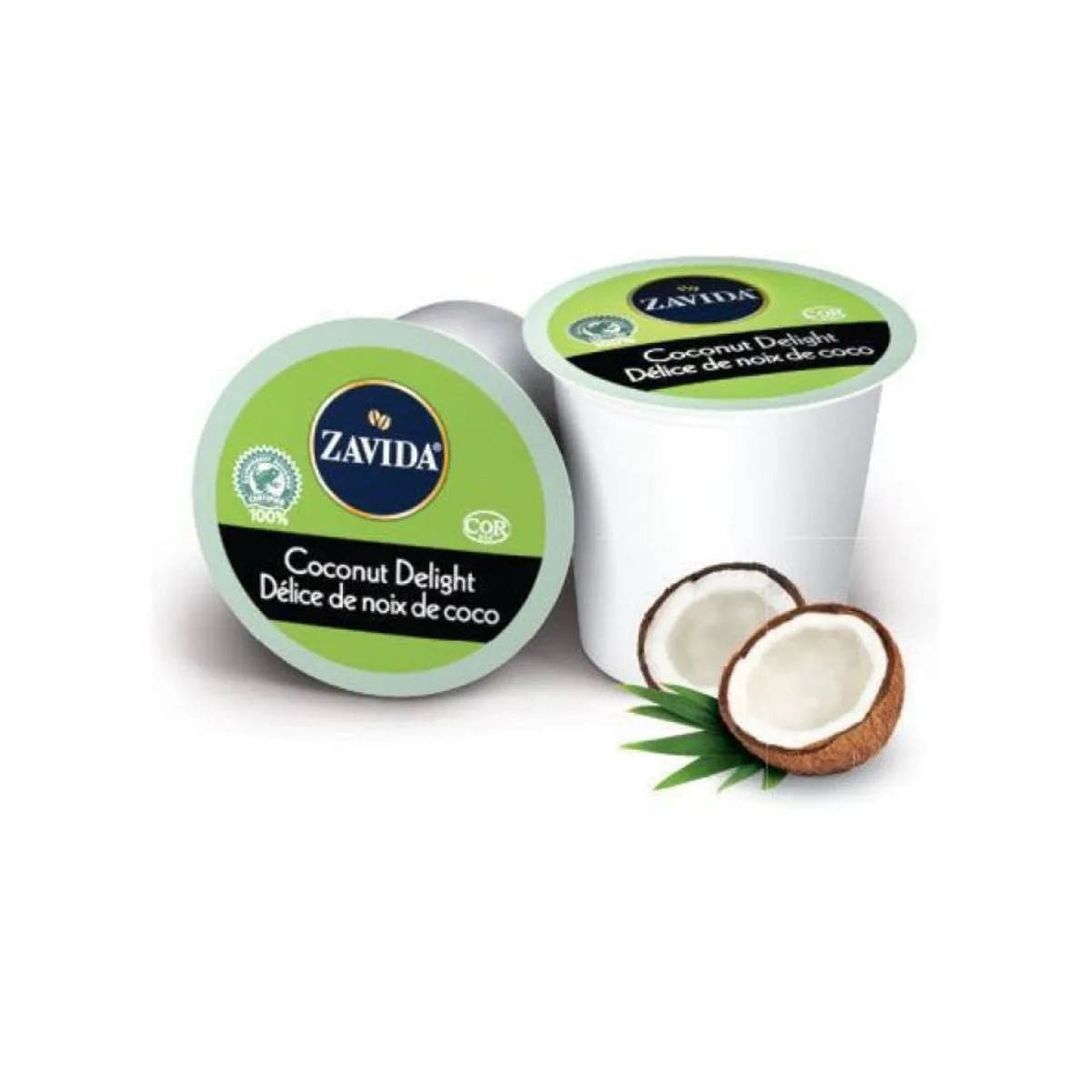 A Zavida Coconut Delight Single-Serve Coffee Pod from Zavida sits next to an identical pod in the background, with the packaging labeled in both English and French. Two halved coconuts and green leaves are displayed beside the pods, highlighting the tropical flavor of this medium roast coffee.