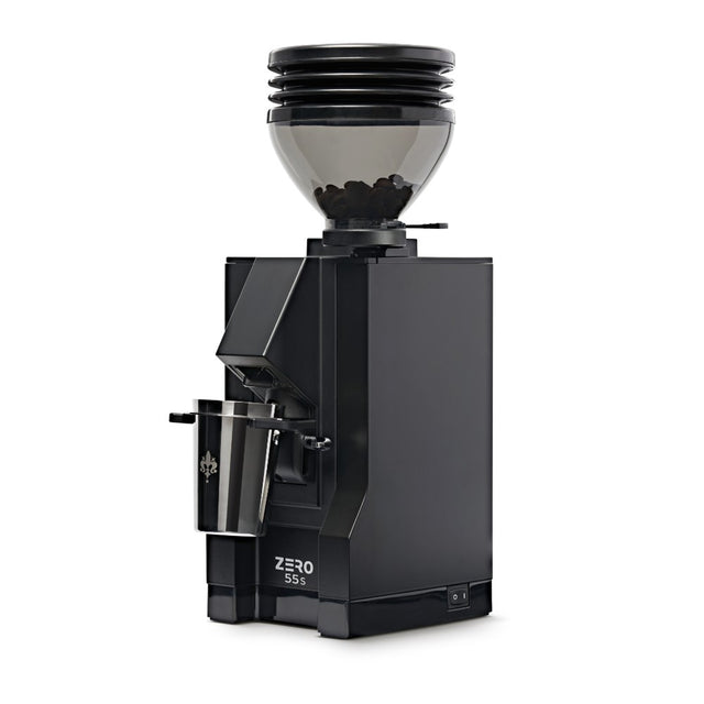 The Eureka Mignon Zero 55s Single Dose Coffee Grinder by Eureka features flat burrs, a transparent bean hopper, a stainless steel grounds container, and "ZERO 55s" on the front—all in a sleek matte black, modern boxy design.