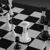 A modern chessboard featuring pieces inspired by the MHW-3BOMBER Knight Impact Tamper 58.35mm (Black), with cylindrical forms and striking black-and-white contrast on the checkered board.