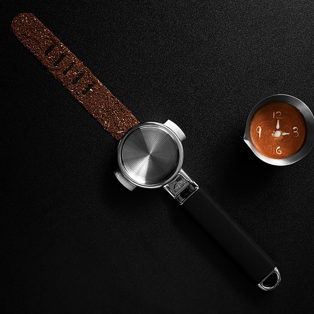 The MHW-3BOMBER YU Series Unibody Bottomless Portafilter 58mm features coffee grounds spelling “TIME” and an espresso with a clock face, symbolizing extraction efficiency on a sleek black background.