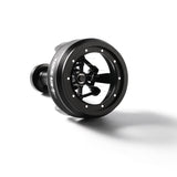A black MHW-3BOMBER YU-Series Cyclone Needle WDT Distributor Tool 58mm lies on its side, showcasing a circular frame with glass center and visible stainless steel needles for precise coffee distribution.