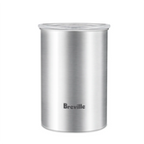 A stainless steel Breville Bean Keeper Coffee Canister BES030BSS, shown on a white background, features the Breville logo on the front and a transparent lid. Designed to complement Breville espresso machines.