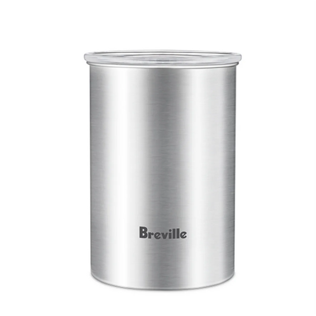 A stainless steel Breville Bean Keeper Coffee Canister BES030BSS, shown on a white background, features the Breville logo on the front and a transparent lid. Designed to complement Breville espresso machines.