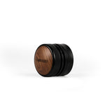 The MHW-3BOMBER Coffee Gravity Distributor 58.35mm features a round black and wood design with a cyclone-shaped base, textured metal band, and an engraved wood-finished top, shown on a white background.