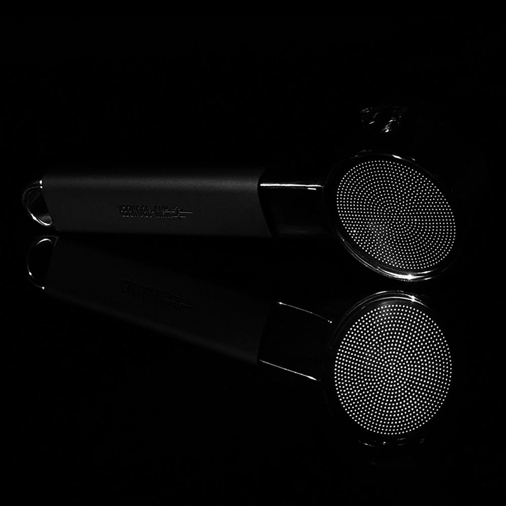 The MHW-3BOMBER YU Series Unibody Bottomless Portafilter 58mm with a black handle is displayed against a black background, its reflection below—engineered for optimal extraction and precise filter holes.