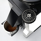 Close-up of the Eureka Mignon Zero 55s Single Dose Coffee Grinder (White) by Eureka, showing its grind size adjustment dial, flat burrs, sleek modern design, and ground coffee falling into a stainless steel container below.