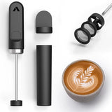 The Subminimal V2 NanoFoamer (Black) by Subminimal, featuring removable parts and mesh filters, is shown with its black case beside a coffee topped with rich microfoam and flawless latte art.