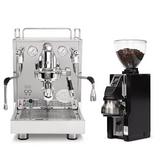 An ECM Mechanika Max Espresso Machine sits beside a black Eureka Mignon Libra 65 grinder, both included in the ECM bundle, with the espresso machine featuring dual gauges and a steam wand.