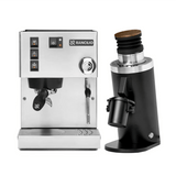 The Rancilio Silvia M V6 Espresso Machine in silver stainless steel sits beside the DF64 Gen 2 Grinder with DLC burrs (black) in this striking bundle, both showcased against a white background.