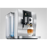 Certainly! Here’s the rewritten sentence using your product data: The Jura Z10 Aluminum White Super Automatic Hot Coffee & Espresso, Cold Brew, & Specialty Beverage Machine 15361 by Jura crafts a beautifully layered coffee drink in a clear glass, featuring a digital display for selecting beverages and a Product Recognising Grinder to ensure perfect flavor with every cup.