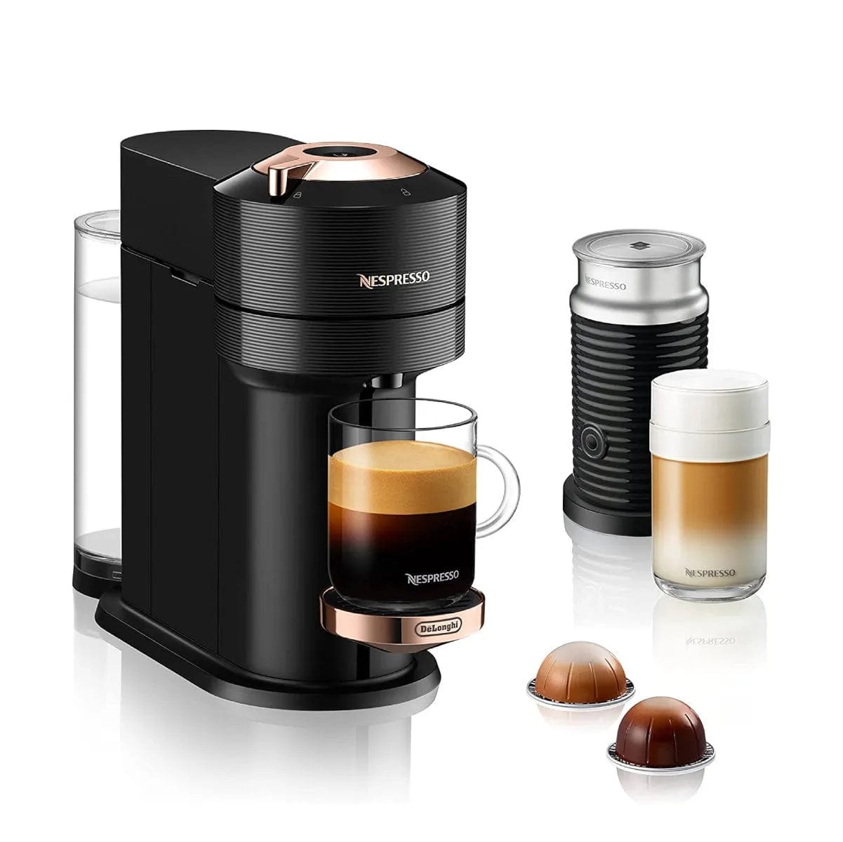 Image of a Nespresso Vertuo Next Premium Coffee and Espresso Machine with Aeroccino by De'Longhi ENV120BAE in black with rose gold, featuring advanced Centrifusion Extraction Technology. Shown with a separate milk frother, a glass mug filled with rich Nespresso coffee, an empty frothing container with a lid, and three coffee capsules. The DeLonghi logo is visible on the machine.