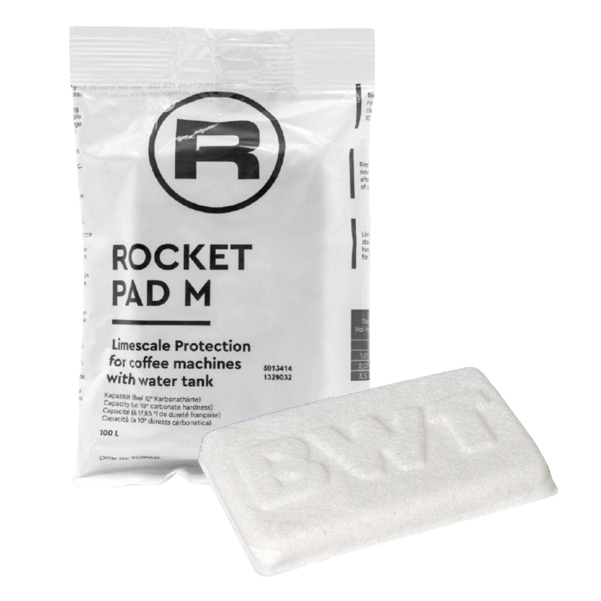 A rectangular white packet labeled "Rocket Espresso Water Softener - BMT Pad M RA92504624" for limescale protection lies behind a rectangular white pad with the letters "Rocket" embossed on it. The packet provides instructions and product details for maintaining espresso machines with a water tank, ensuring optimal performance and longevity.