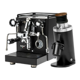 The Quick Mill Rubino Plus Espresso Machine (Black) & Eureka Mignon Zero 65 All Purpose Grinder (Black) Bundle from Quick Mill features a sleek black espresso machine with silver accents alongside a matching all-purpose grinder with a wooden top, both displayed on a white background—ideal for preparing fresh single-dose espresso.