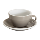 A Loveramics Egg 200ml Cappuccino Cup with handle, in taupe, rests on its matching saucer against a white background, reflecting the style of the World Latte Art Championship cup.