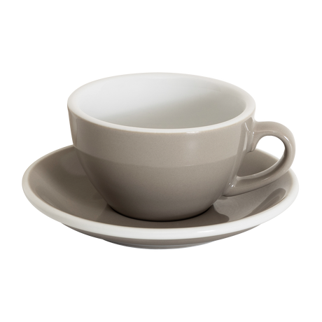 A Loveramics Egg 200ml Cappuccino Cup with handle, in taupe, rests on its matching saucer against a white background, reflecting the style of the World Latte Art Championship cup.