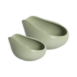 Two matte light green Loveramics Coffee Dosing Trays, crafted in smooth ceramic with curved, asymmetrical edges and a clean, modern aesthetic, nest side by side on a white background.