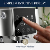 A hand selects the "Espresso" option on the touchscreen display of the De'Longhi Magnifica Start Super Automatic Espresso Machine ECAM22022SB (Silver), featuring intuitive icons for various drinks. Text above reads, "Simple & Intuitive Display.