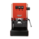 A Gaggia Classic Evo Pro Espresso Machine RI9380/53 in Lobster Red / Orange, featuring three control buttons on the top, a steam wand on the right, and a portafilter holder in the center. The machine is supported by a black base with a small drip tray at the bottom, ensuring professional results every time.