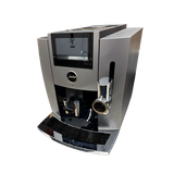 Jura S8 Super Automatic Coffee Machine 15755 (Dark Inox) in dark gray with a built-in touchscreen display, AromaG3 grinder, and adjustable chrome spouts.