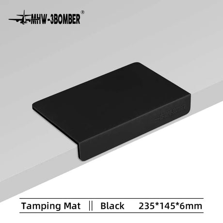 The MHW-3BOMBER Silicone Corner Tamping Mat SP5312B (Black), sized 235 x 145 x 6 mm, features an overhanging edge—an essential barista accessory for any setup.