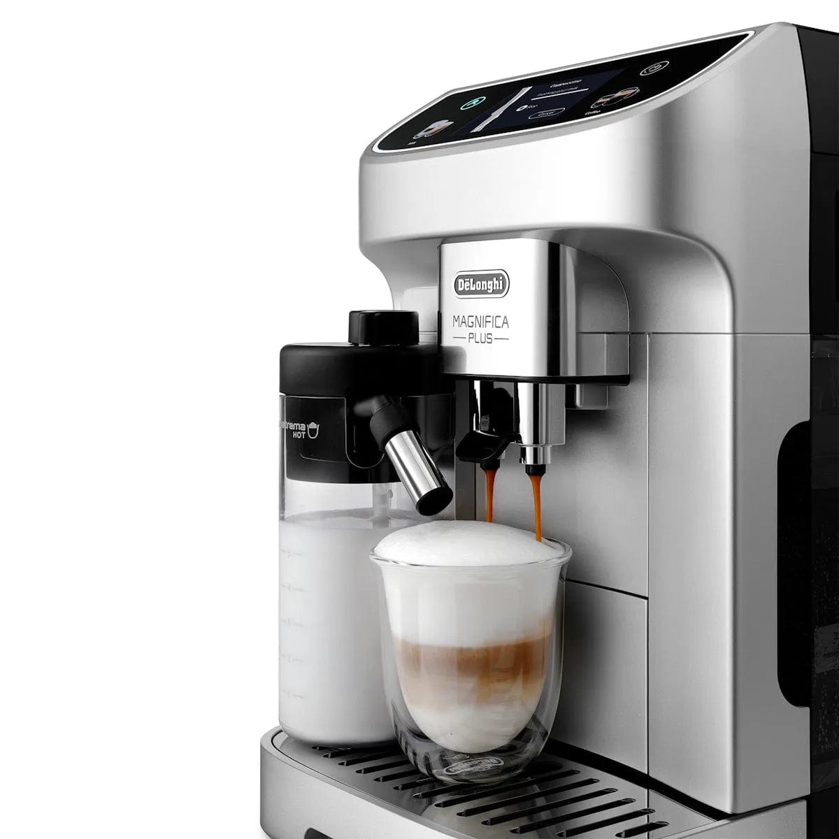 The DeLonghi Magnifica Plus Super Automatic Espresso Machine with LatteCrema System ECAM32070SB brews coffee into a clear glass of frothed milk, using a milk frother attached to the left side.