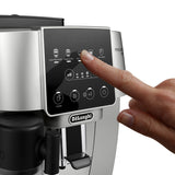 A hand is pressing the espresso option on the digital touch screen of the DeLonghi Magnifica Start Super Automatic Espresso Machine with LatteCrema System ECAM22080SB. The display features icons for a variety of beverages—including latte, cappuccino, espresso, and hot water—each expertly crafted by the integrated conical burr grinder and LatteCrema System.