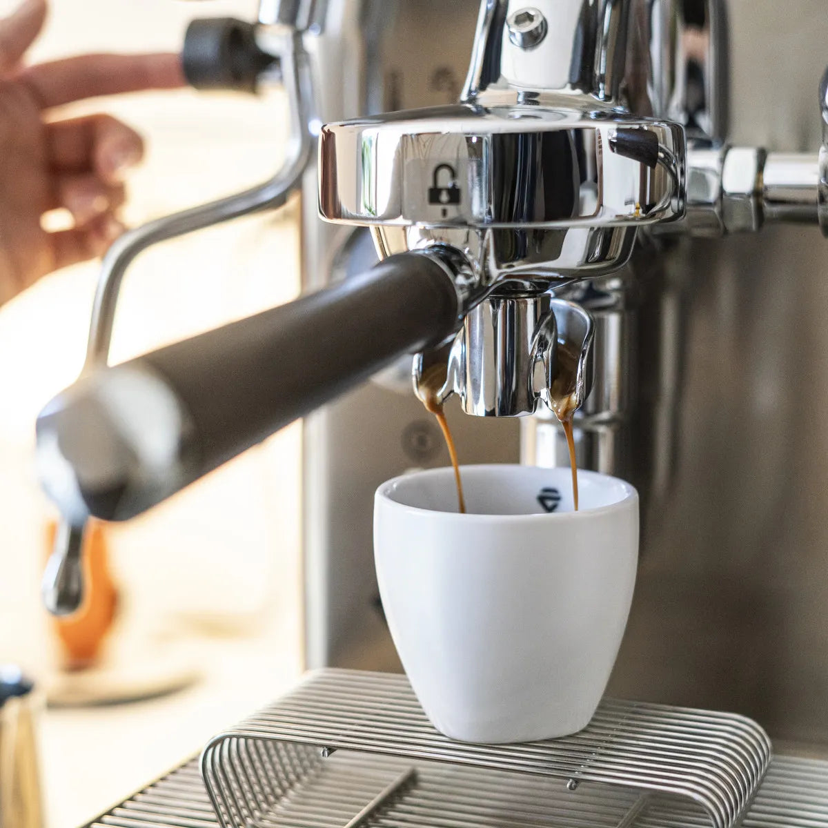 Close-up of the Lelit Mara X3 Semi-Automatic Heat-Exchange Espresso Machine (PL62X3, Stainless Steel) brewing espresso into a white cup, with a hand adjusting the electronic flow control lever.