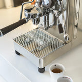 A close-up of the Lelit Mara X3 Semi-Automatic Heat-Exchange Espresso Machine PL62X3 (Stainless Steel) on a countertop, with two white espresso cups nearby; its portafilter and steam wand highlight advanced electronic flow control.