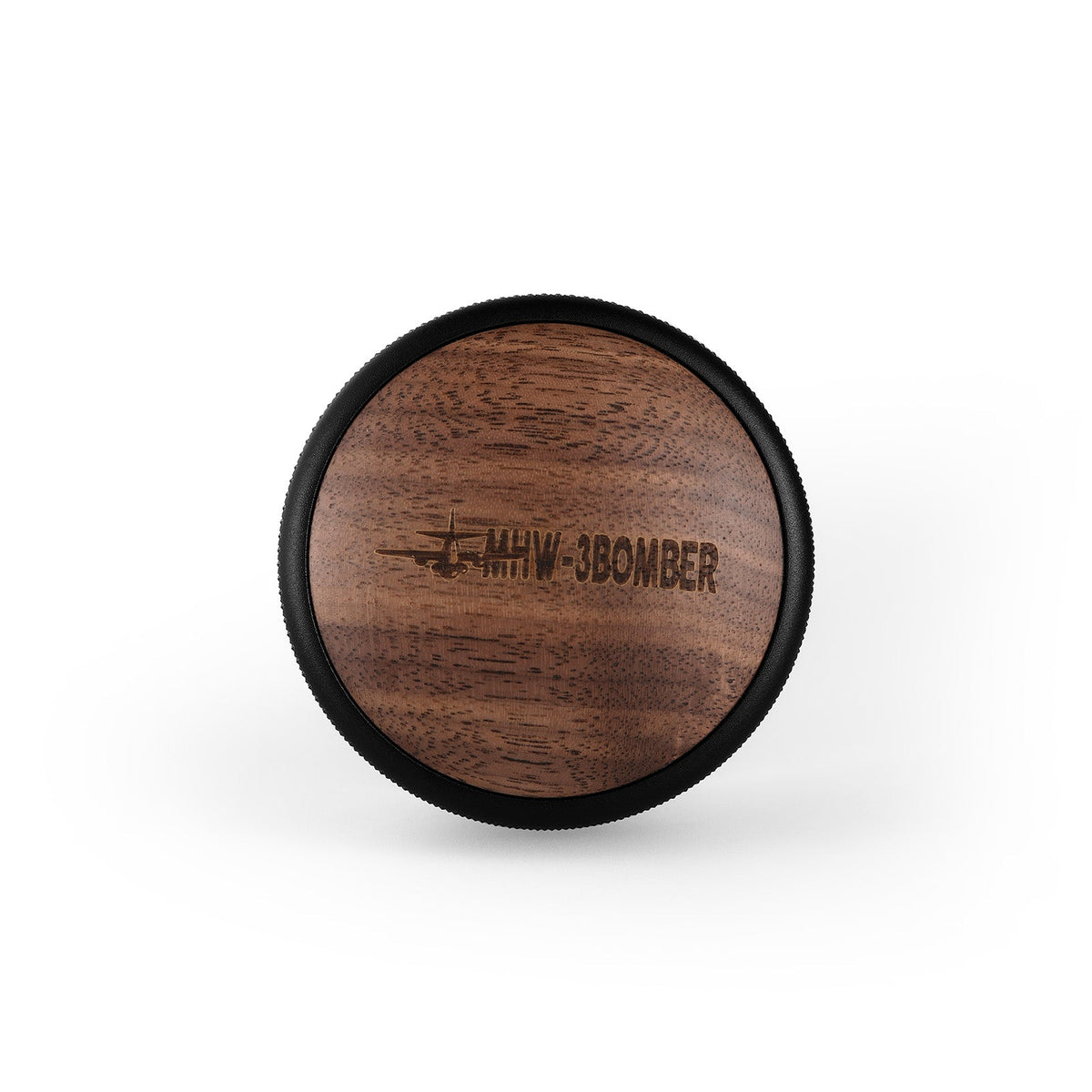 A wooden MHW-3BOMBER CD Series Wood Lid Coffee Distributor 58.35mm features a dark edge and airplane engraving, showcasing the precision craftsmanship of the MHW-3BOMBER brand against a white background.