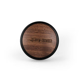 A wooden MHW-3BOMBER CD Series Wood Lid Coffee Distributor 58.35mm features a dark edge and airplane engraving, showcasing the precision craftsmanship of the MHW-3BOMBER brand against a white background.