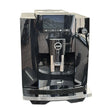 A Jura E4 Super Automatic Coffee Machine 15466 in Piano Black by Jura, featuring a digital display, dual spouts, and the innovative Pulse Extraction Process (P.E.P.), is shown on a white background.
