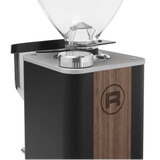 A close-up of the Rocket Giannino Coffee Grinder R01RG099B3L12 (Black-Wood) by Rocket, featuring a clear bean hopper, micrometric grind adjustment dial, and a side wooden panel with a circular "R" logo.