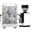 The ECM Mechanika Max Espresso Machine with its dual pressure gauges stands next to the Eureka Mignon Zero 55s Single Dose Coffee Grinder in white, both from ECM, against a plain white background.