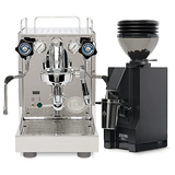 The ECM Mechanika Slim with PID Espresso Machine, featuring a compact stainless steel design with knobs, gauges, and precise temperature control, stands beside the Eureka Mignon Zero 55s Single Dose Coffee Grinder in matte black—both from ECM—set against a white background.