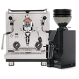 A Profitec Drive Espresso Machine bundled with the Eureka Mignon Zero 55s Single Dose Coffee Grinder in matte black is showcased on a pristine white background. The stainless steel espresso machine boasts PID temperature control and an iconic E61 group head with dials and wands, while the grinder sits beside it, filled with coffee beans.