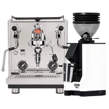 A Profitec Drive Espresso Machine in stainless steel, featuring dials, levers, and PID temperature control, stands beside a white Eureka Mignon Zero 55s Single Dose Coffee Grinder as part of the Profitec Drive Espresso Machine with Eureka Mignon Zero 55s (White) Bundle, all set against a plain background.