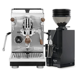 The Profitec Jump Espresso Machine & Eureka Mignon Zero 55s Single Dose Coffee Grinder (Matte Black) Bundle by Profitec, featuring a classic E61 group head and sophisticated wooden accents on the espresso machine, is displayed side by side against a clean white background. The sleek black grinder is filled with fresh coffee beans, highlighting the bundle’s elegant design and premium craftsmanship.