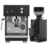 The Profitec Move Dual Boiler Espresso Machine (Black) sits next to the Eureka Mignon Zero 55s Single Dose Coffee Grinder (Matte Black), both featuring digital displays and elegant wooden accents. The espresso machine’s compact stainless steel design and integrated steam wand, paired with the grinder’s clear hopper filled with coffee beans, deliver professional-quality espresso in any setting.