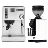 A Rancilio Silvia M V6 Espresso Machine in silver stainless steel is placed next to a white Eureka Mignon Zero 55s Single Dose Coffee Grinder with a clear hopper, both from the brand Rancilio, set against a white background.