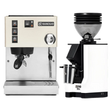A Rancilio Silvia M V6 Espresso Machine (White), constructed with stainless steel and equipped with buttons, a vibratory pump, and a steam wand, sits beside a matching Eureka Mignon Zero 55s Single Dose Coffee Grinder (White) from the Rancilio brand, both displayed on a plain background.
