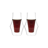 Two Kruve EQ Inspire double-walled glass cups, each 150ml, filled with dark liquid, likely coffee, have a transparent curvy design with a narrow middle section to enhance flavor and maintain an even level.